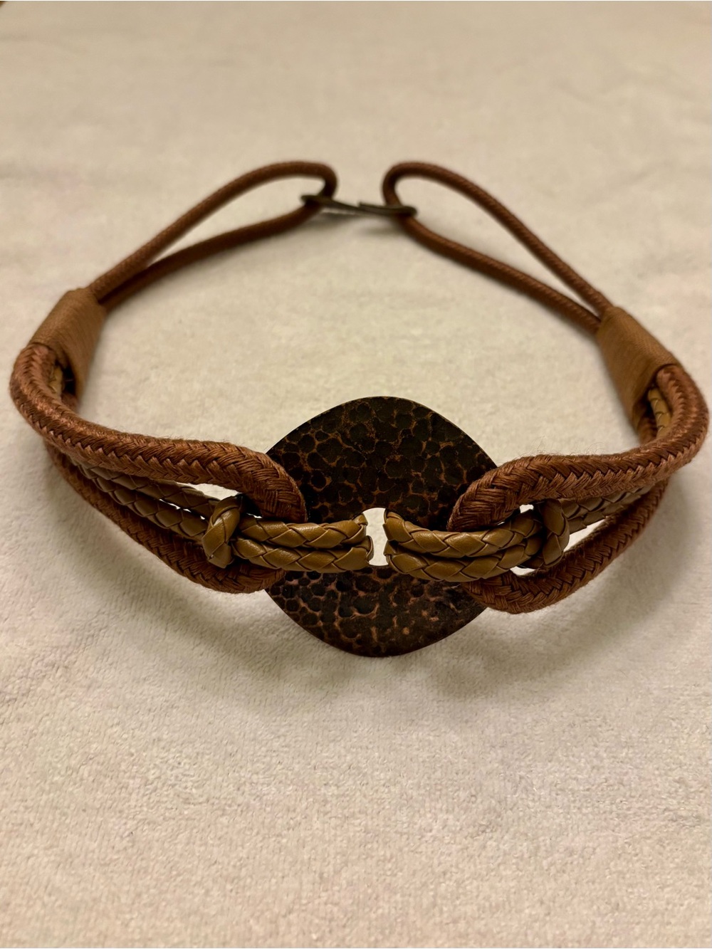 Vintage woven waist belt with hammered metal medallion